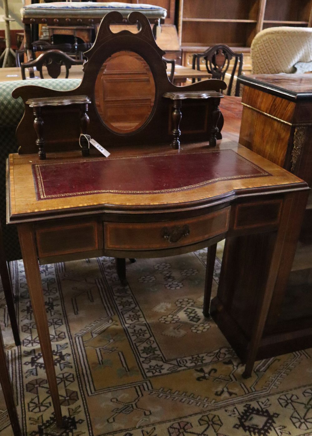 A late Victorian satinwood banded mahogany bowfront writing table, width 76cm, depth 45cm, height 115cm